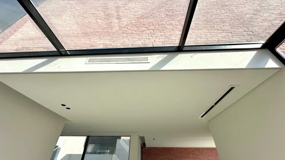Linear diffuser in a skylit room