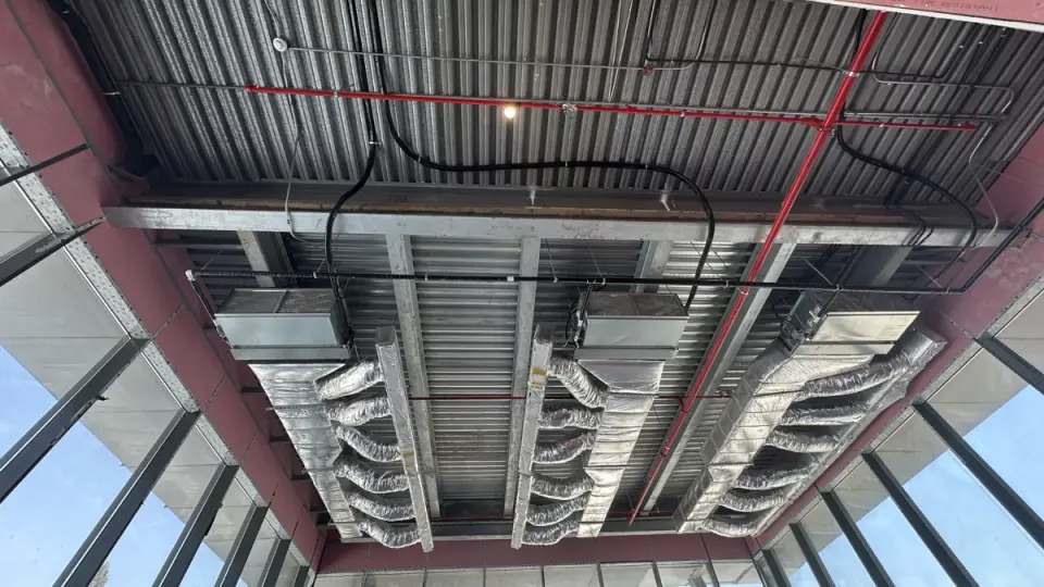 Insulated duct runs beneath a steel canopy
