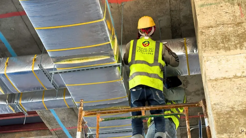 Installing insulated ductwork from scaffolding